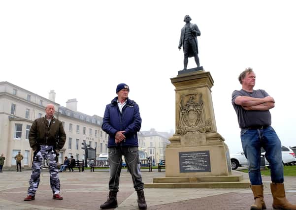 Activists 'guard' the Captain Cook statue in Whitby from the risk of vandalism.