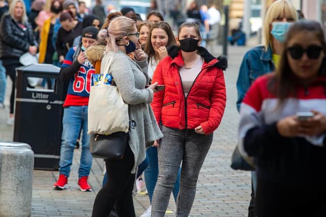 Shoppers made sure to wear face masks as they queued to get in stores. Photo: Bruce Rollinson.