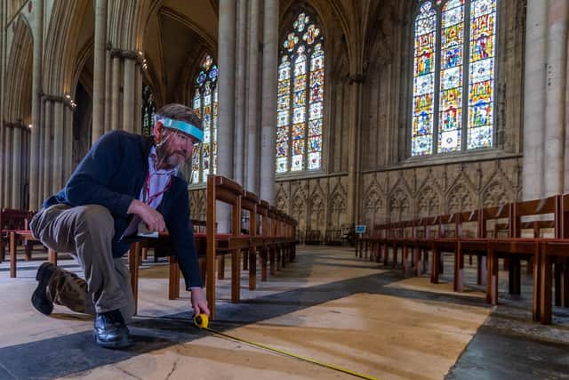 Alex Carberry, Head Verger,  measuring out the two metre mark for the social distancing of the chairs. Picture: James Hardisty
