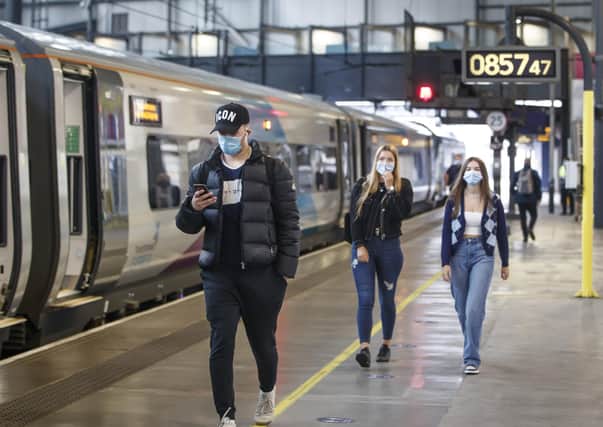 Commuters at Leeds station on Monday as the wearing of face coverings became mandatory.