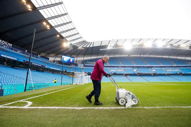 Manchester City head groundsman Lee Jackson prepares the pitch ahead of Manchester City v Arsenal. (Picture: Martin Rickett/PA Wire)