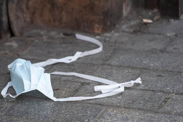 A discarded face mask on Oxford Street, London, as further coronavirus lockdown restrictions are lifted in England. Photo: PA
