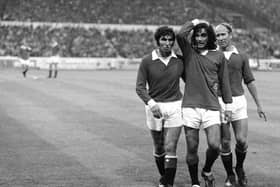 An unbelieving George Best, the Manchester United and Irish International, is helped off the field by teammates (on the right) Bobby Charlton and (on the left) Tony Dunne during a match against Chelsea at Stamford Bridge in 1971. (Photo by Central Press/Getty Images)