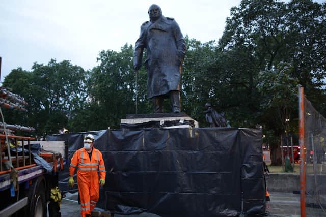 Workers finish taking down boarding and scaffolding around the Winston Churchill statue on Parliament Square, London.