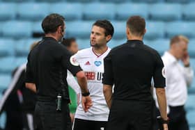 Sheffield United's Oliver Norwood (left) speaks to referee Michael Oliver after the Premier League match at Villa Park (Picture: PA)