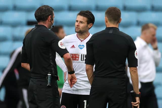 Sheffield United's Oliver Norwood (left) speaks to referee Michael Oliver after the Premier League match at Villa Park (Picture: PA)
