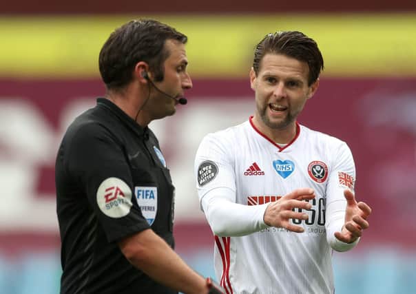 Sheffield United's Oliver Norwood talks with referee Michael Oliver after goalline technology failed to award the Blades a goal at Aston Villa on Wednesday. (Picture: Paul Ellis/PA).