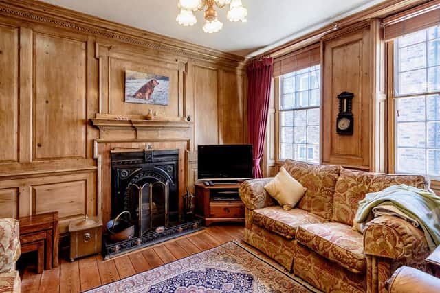 The sitting room with original pitch pine panelling