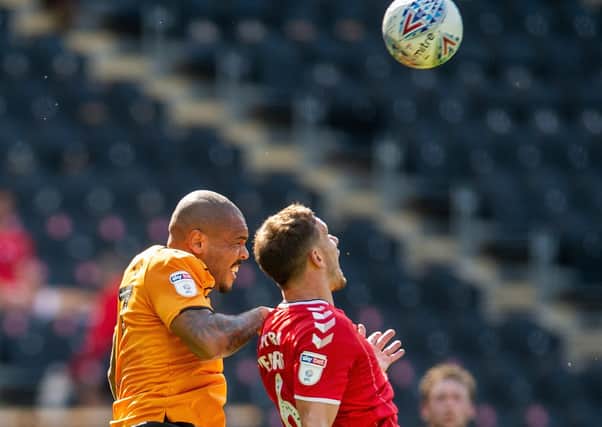 Josh Magennis and Jason Pearce challenge for a high ball (Picture: Bruce Rollinson)