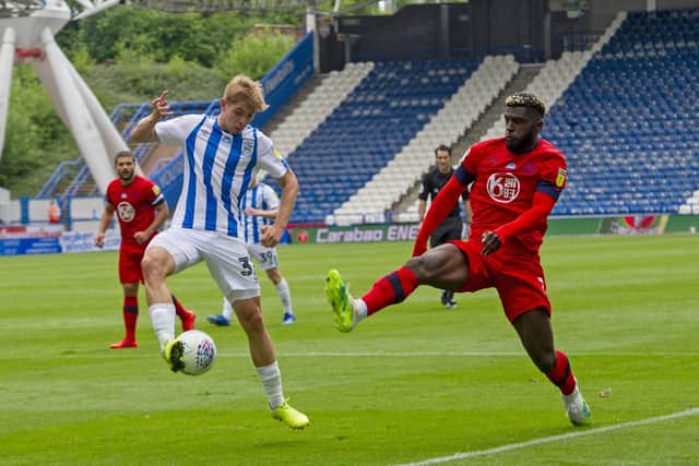 Huddersfield's Emile Smith Rowe
 with Wigan's Cedric Kipre. (Picture: Tony Johnson)