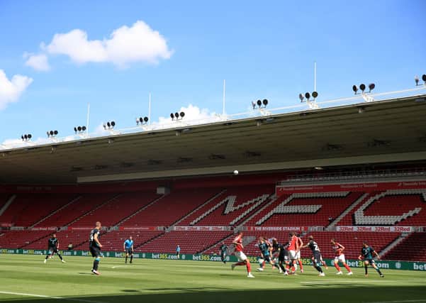 QUIET TIME: Middlesbrough and Swansea City play in front of empty stands at the Riverside Stadium: Owen Humphreys/PA