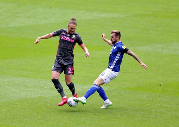 Leeds United's Luke Ayling (left) and Cardiff City's Joe Ralls battle for the ball at Cardiff City Stadium. Picture: David Davies/PA