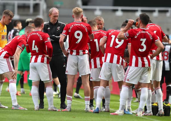 Sheffield United manager Chris Wilder talks to his players as they take a drinks break at St. James's Park. Picture: Simon Bellis/Sportimage