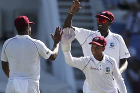 West Indies' captain Jason Holder, back right, and wicket keeper Shane Dowrich celebrate with Shannon Gabriel, left, after the dismissal of England's Moeen Ali in January 2019. AP/Ricardo Mazalan