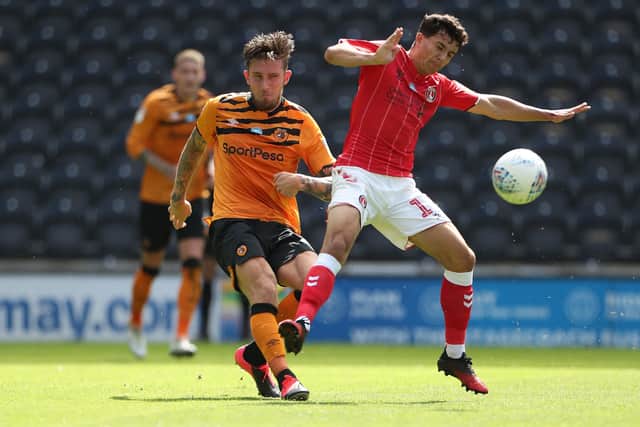 On his way back: Charlton Athletic's Alfie Morgan goes up against Hull City's Angus MacDonald, who was returning after overcoming cancer. Picture: PA