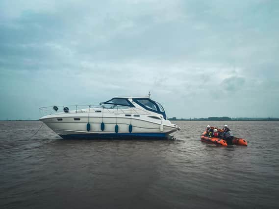 The yacht had run aground with three people on board.