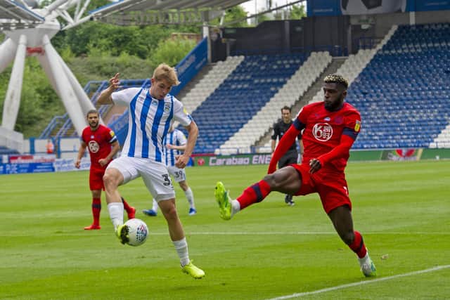 Closed down: Huddersfield's Emile Smith Rowe with Wigan's Cedric Kipre.