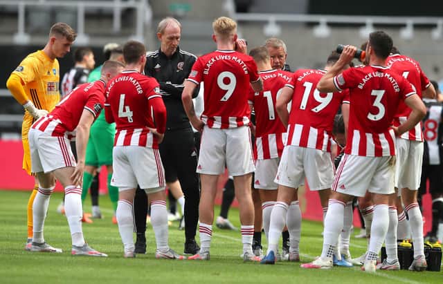 Sheffield United manager Chris Wilder talks to his players as they take a drinks break during the Premier League match at St. James's Park. Picture: Simon Bellis/Sportimage