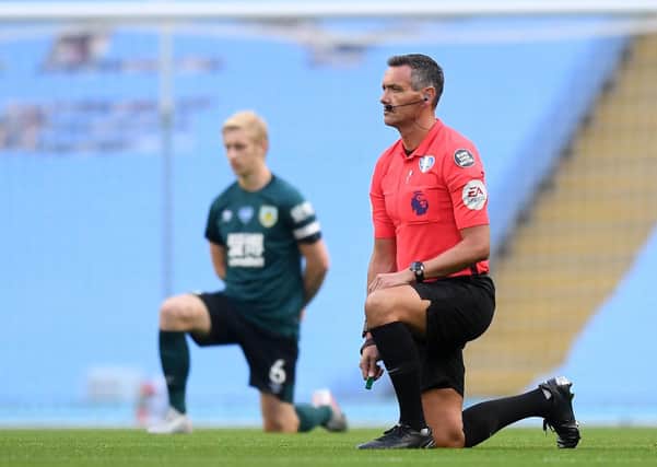 Taking the knee: Referee Andre Marriner before the Premier League match at the Etihad Stadium, Manchester. Picture: PA