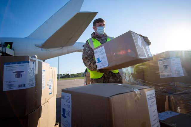Reservists unload an airlift of PPE. Photo: Cpl Andy Reid/Ministry of Defence