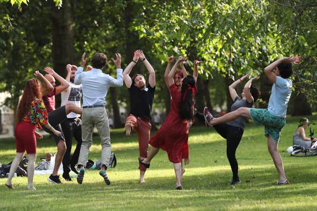 A group of people exercising in a park as Boris Johnson announces a further lifting of lockdown restrictions.