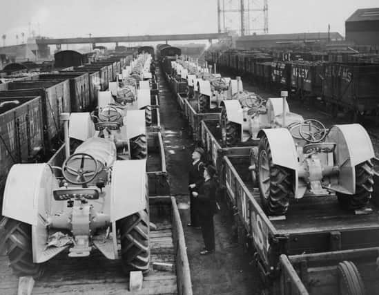 Two trainloads of new agricultural tractors ready to leave the factory, England, 17th October 1939. The tractors are being produced at a car factory, and production is linked to the British government's wartime 'Grow More Food' campaign. (Photo by Harry Todd/Fox Photos/Hulton Archive/Getty Images)