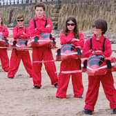 Children prepare their own Armed Forces Day by dressing up as the Red Arrows on Scarborough's beach. Photo: Tony Bartholomew.