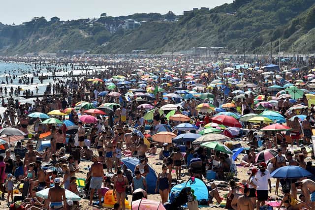 Beachgoers enjoy the sunshine as they sunbathe and play in the sea on Bournemouth beach in Bournemouth, southern England, on June 25, 2020. (Photo by GLYN KIRK/AFP via Getty Images