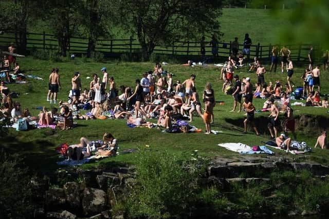 Crowds gather in Burley-in-Wharfedale as people head to the River Wharfe on Thursday, May 26.