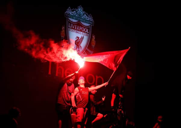 Champions: Liverpool fans let off flares outside Anfield after being crowned Premier League champions following Manchester City's 2-1 defeat at Chelsea. Picture: Martin Rickett/PA
