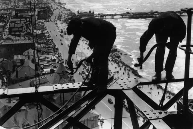 15th August 1934:  Balancing on girders high above the promenade workmen repair Blackpool Tower.  (Photo by Fox Photos/Getty Images)