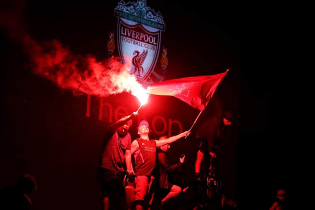 Liverpool fans let off flares outside Anfield, Liverpool after winning the title (Picture: Martin Rickett/PA Wire)