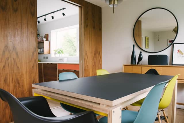 The dining table and sliding doors to the Wood & Wire kitchen on the left
