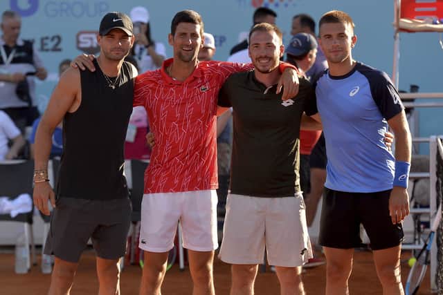 In this photo taken June 19, 2020, Serbian tennis player Novak Djokovic, second left, poses with Bulgaria's Grigor Dimitrov, left, Serbia's Viktor Troicki and Croatia's Borna Coric, right, at a tournament in Zadar, Croatia. Djokovic has tested positive for the coronavirus after taking part in a tennis exhibition series he organized in Serbia and Croatia. (AP Photo/Zvonko Kucelin)