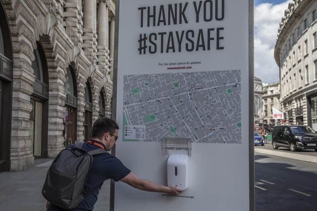A man sanitises his hands on Regent Street as non-essential stores re-open for the first time since the nationwide lockdown came into force, on June 16, 2020 in London  (Photo by Dan Kitwood/Getty Images)
