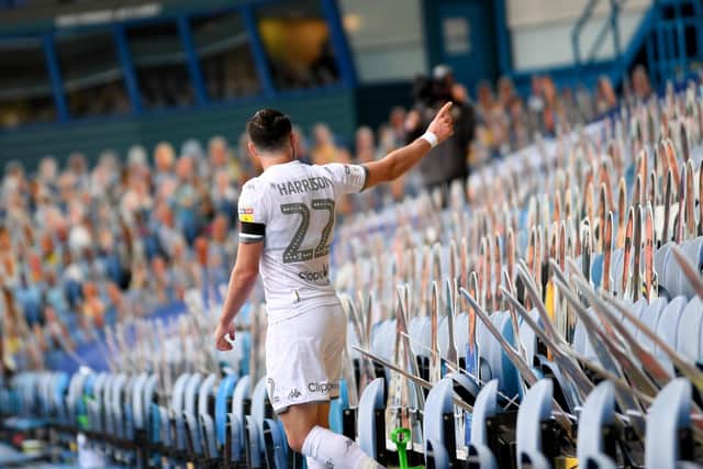 Cardboard support: Jack Harrison waves towards the 15,000 'crowdies' after scoring the third goal.