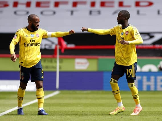 Nicolas Pepe (right) celebrates his goal with Alexandre Lacazette. Picture: Andrew Boyers/NMC Pool/PA Wire.
