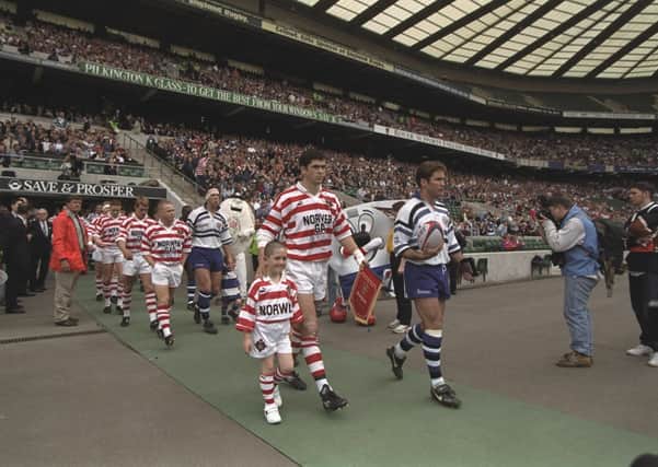 25 May 1996 - Bath and Wigan teams walking out with Wigan's mascot before the Rugby Union match of the clash of the codes,  held at Twickenham, London. Bath won  44-19.  (Picture: Mike  Hewitt/Allsport)