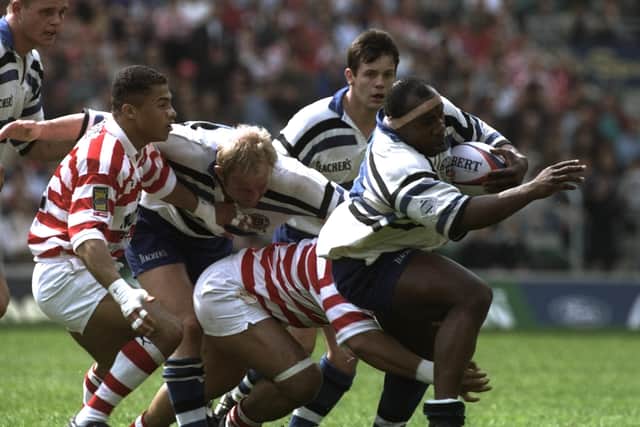 Victor Ubogu (right) of Bath charges away from the  Wigan defence in the Rugby Union leg of the clash of the codes, Rugby Union and League, at Twickenham, London. (Picture: Mike Hewitt/Allsport)