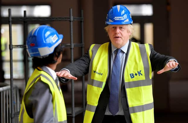 Prime Minister Boris Johnson talks with Year Ten pupil Vedant Jitesh during a visit to Ealing Fields High School in west London. Picture: Toby Melville/PA Wire