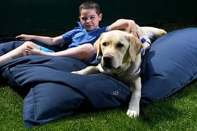 Thomas with his Support Dog Marky. Picture by Simon Hulme