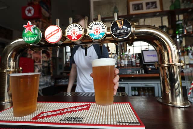 A barman serving takeaway drinks at Charrington's Noted Ales And Stout pub in London, as further coronavirus lockdown restrictions are lifted in England. Picture: Yui Mok/PA Wire