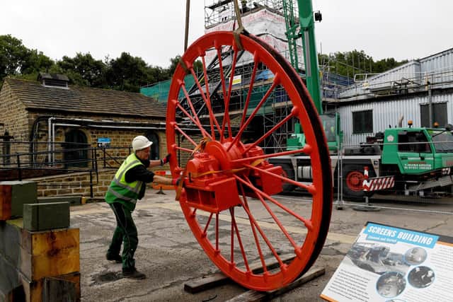 The newly restored pit wheel is put into place at the National Mining Museum, Wakefield. Pictures by Simon Hulme