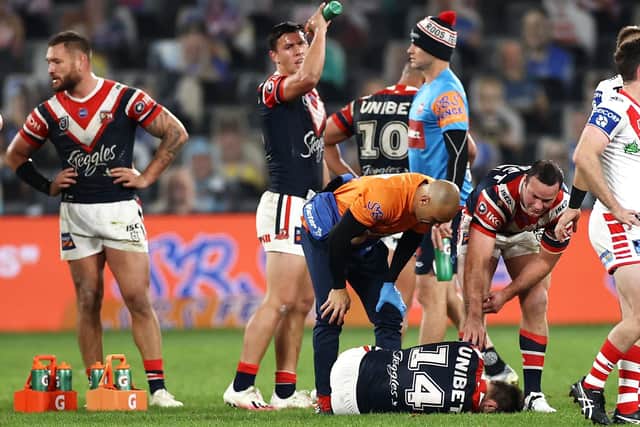 Boyd Cordner of the Roosters and a trainer check on the injured Sam Verrills of the Roosters during the round seven NRL match between the Sydney Roosters and the St George Illawarra Dragons at Bankwest Stadium on June 26, 2020 in Sydney, Australia. (Picture: Cameron Spencer/Getty Images)