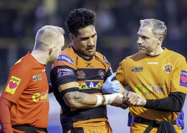 Physio Matt Crowther tends to Castleford's Jesse Sene-Lefao  after scoring a try against Wakefield. (Picture: SWPix.com)