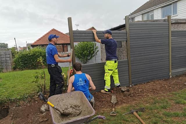 The workers fixed the fence which had been put in by 'cowboy builders'
