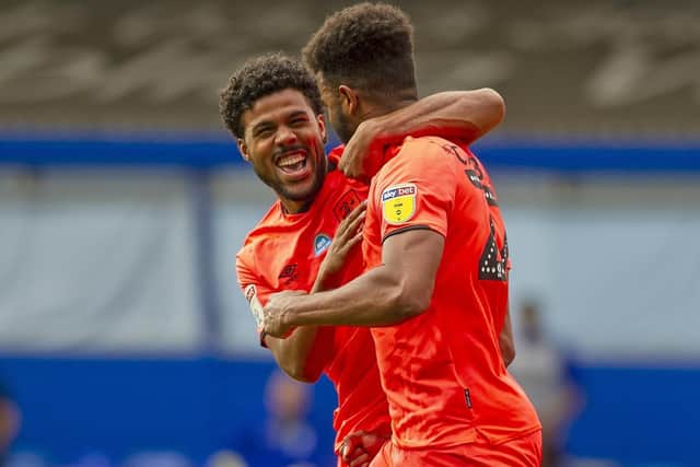 Terriers' Elias Kachunga congratulates Fraizer Campbell after the striker scored the second goal. Picture Tony Johnson