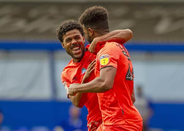Well done:
 Elias Kachunga congratulates Fraizer Campbell after the Town striker scored the second goal at Birmingham. Picture: Tony Johnson