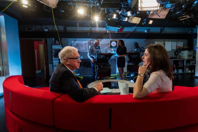 BBC Look North Presenters Harry Gration, on the sofa with Keeley Donovan, in the studio whilst Amy Garcia, chats with the cameraman during a break from filming.