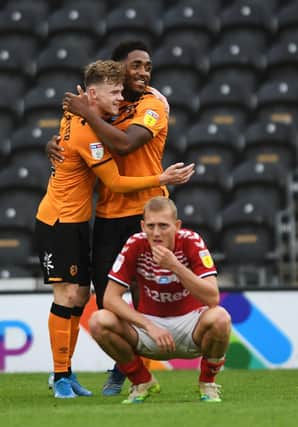 Hull's Mallik Wilks celebrates with Keane Lewis-Potter at full time as Middlesbrough's George Saville sinks to his knees. Picture Jonathan Gawthorpe